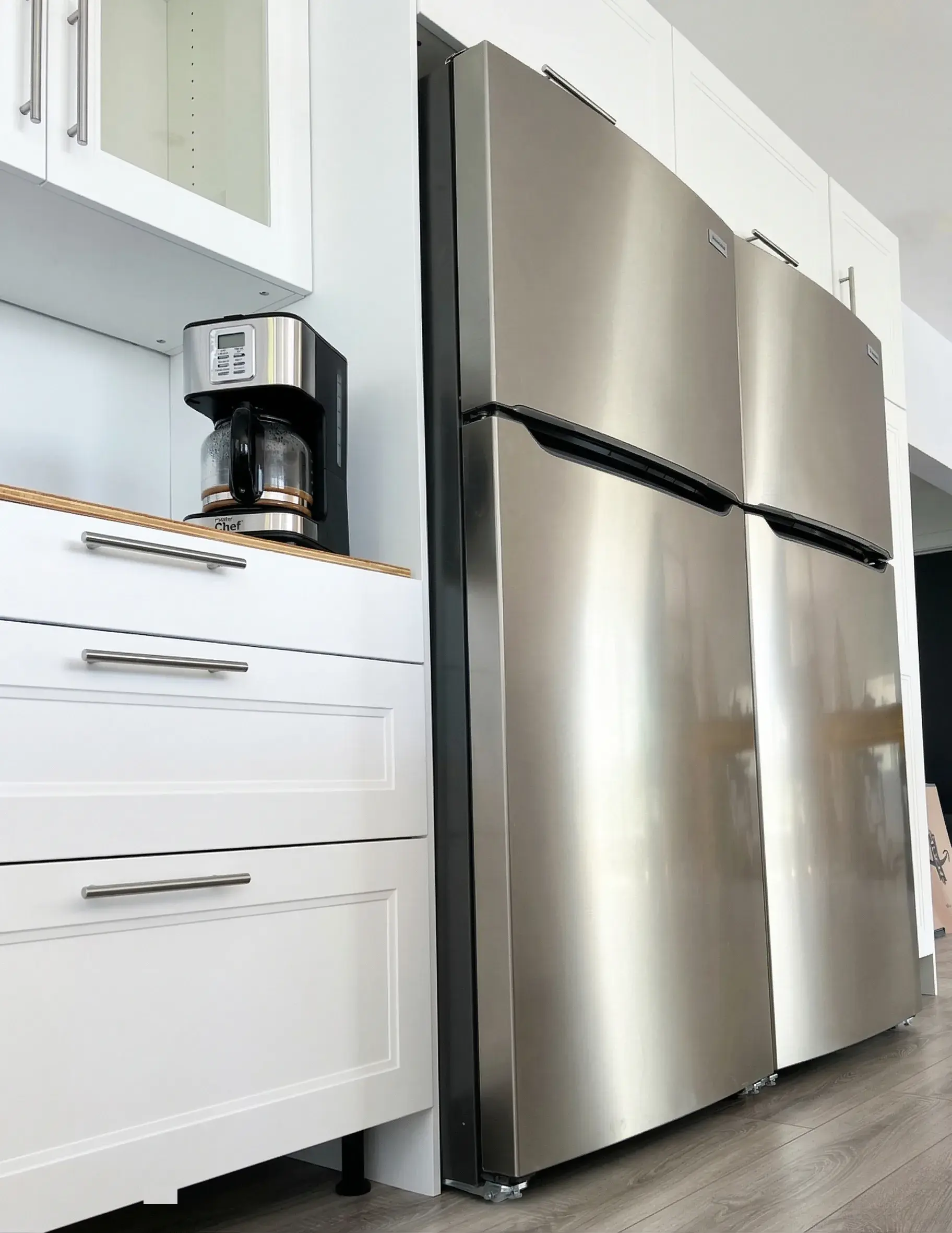 Cuisine équipée avec grand réfrigérateur inox et cafetière